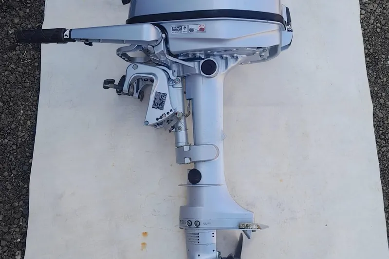  Yacht Photos Pics Outboard motor on white surface, viewed from the side.