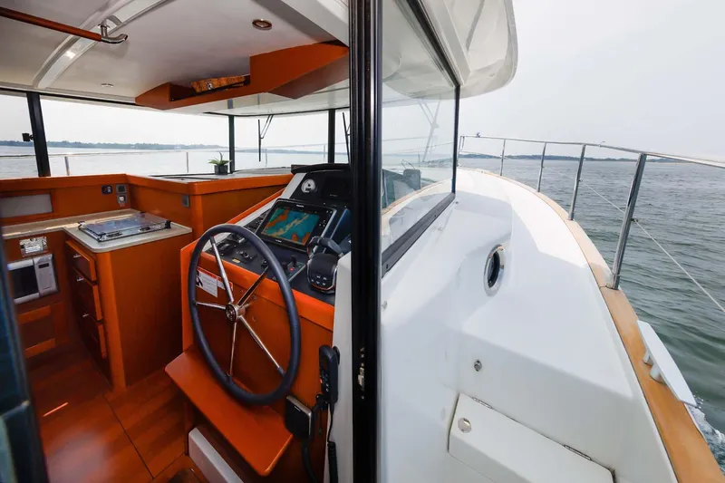 Gotali Yacht Photos Pics 2016 Beneteau Swift Trawler 44 helm and interior view on open water.