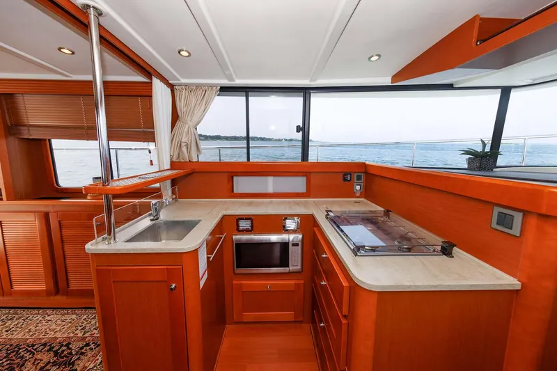 Gotali Yacht Photos Pics Interior of 2016 Beneteau Swift Trawler 44, featuring a modern kitchen with ocean view.