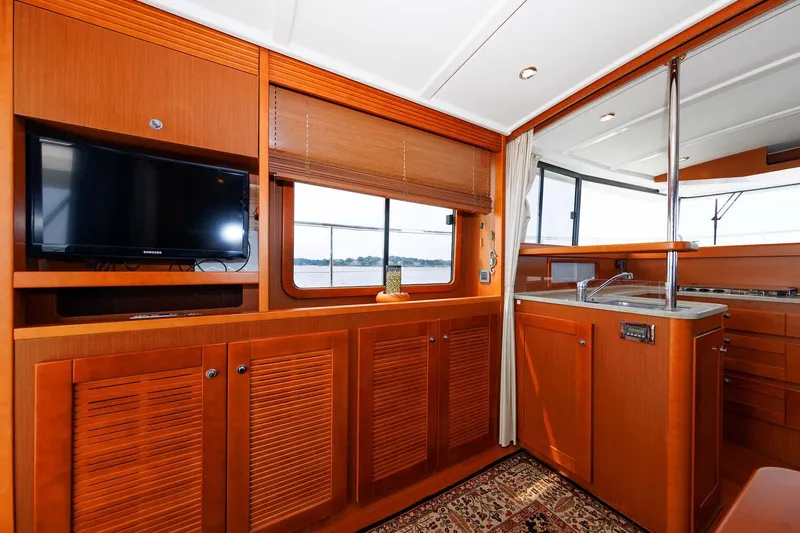 Gotali Yacht Photos Pics Interior of 2016 Beneteau Swift Trawler 44 with wood cabinetry and TV.