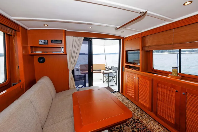Gotali Yacht Photos Pics 2016 Beneteau Swift Trawler 44 interior with cozy seating and elegant wood finishes.