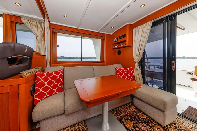 Gotali Yacht Photos Pics Interior of 2016 Beneteau Swift Trawler 44 with cozy seating and scenic window view.