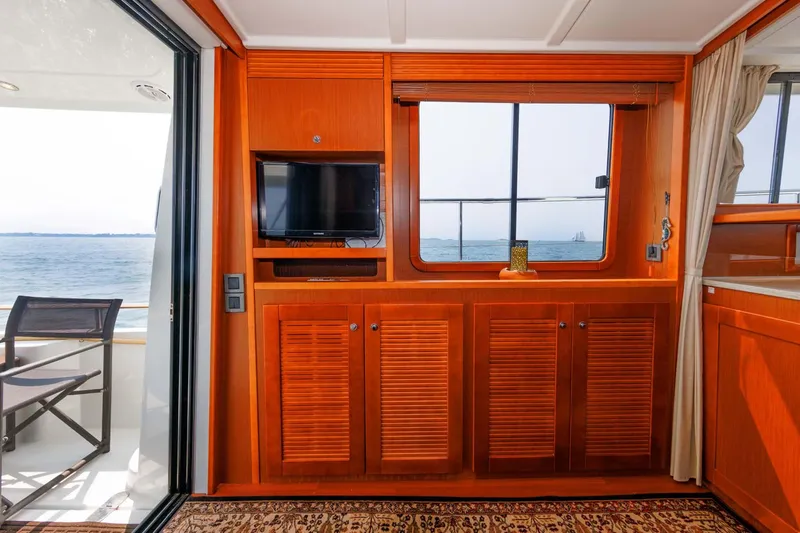 Gotali Yacht Photos Pics Interior of 2016 Beneteau Swift Trawler 44 with wood cabinetry and ocean view.