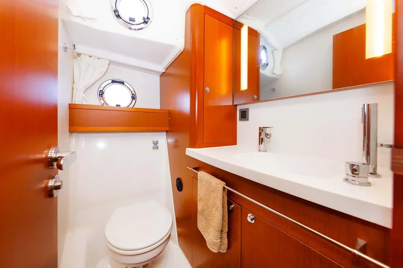 Gotali Yacht Photos Pics 2016 Beneteau Swift Trawler 44 bathroom with wood cabinetry and modern fixtures.
