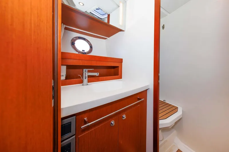 Gotali Yacht Photos Pics 2016 Beneteau Swift Trawler 44 bathroom with wooden cabinetry and modern fixtures.