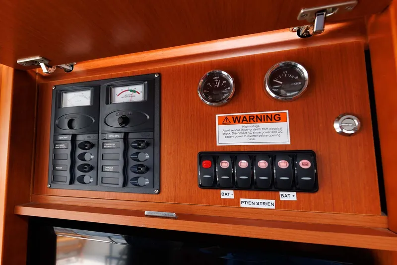 Gotali Yacht Photos Pics Control panel of 2016 Beneteau Swift Trawler 44 with gauges and warning label.