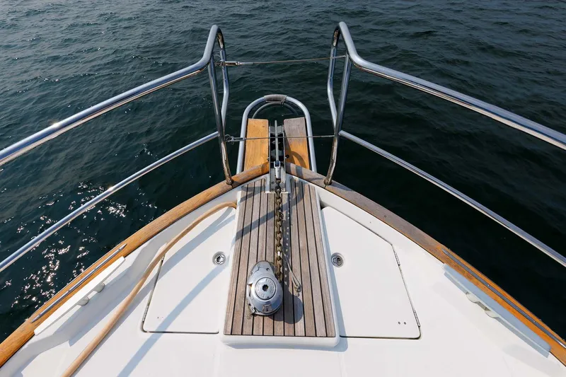 Gotali Yacht Photos Pics 2016 Beneteau Swift Trawler 44 bow with anchor chain, wooden deck, and railing.