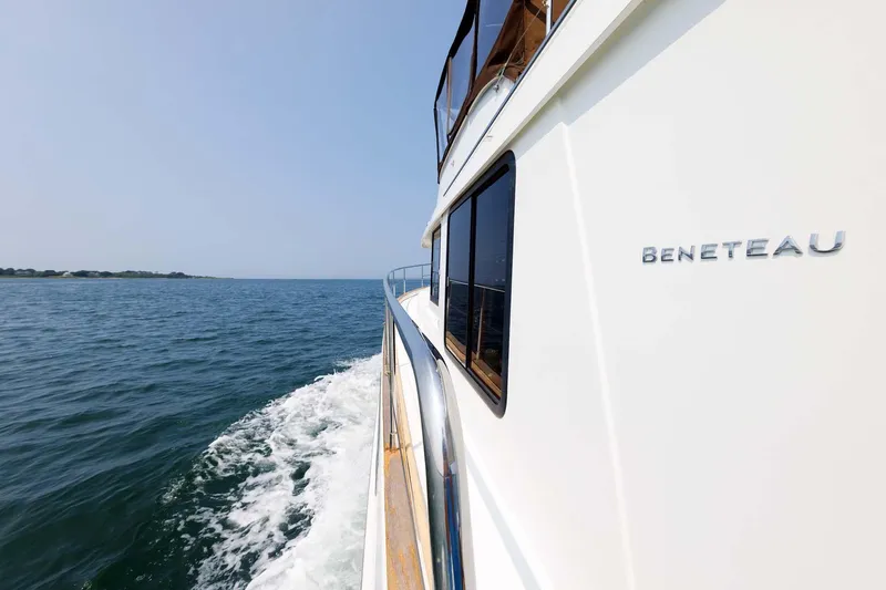 Gotali Yacht Photos Pics 2016 Beneteau Swift Trawler 44 cruising on open water, side view.