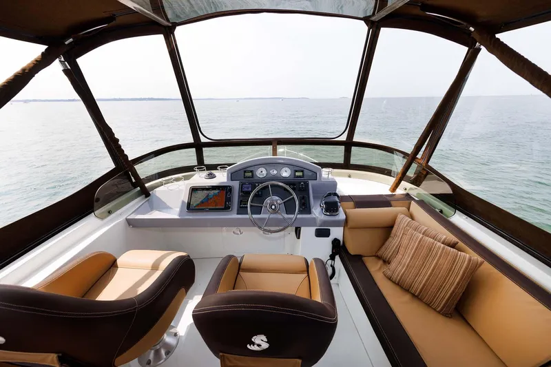 Gotali Yacht Photos Pics 2016 Beneteau Swift Trawler 44 helm with ocean view, featuring modern navigation equipment and seating.