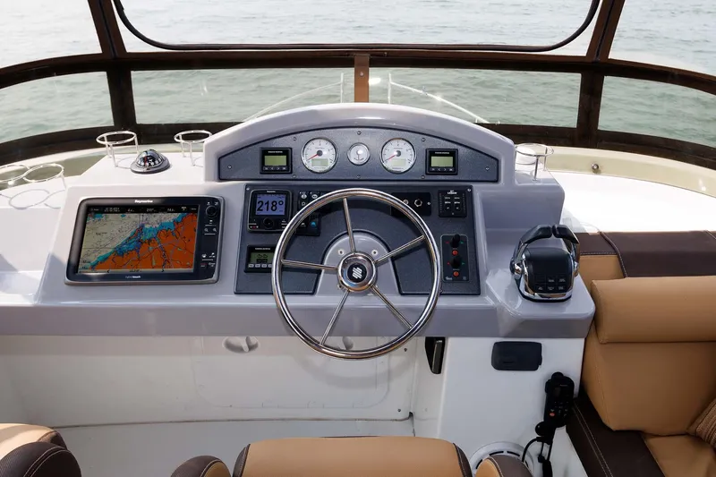 Gotali Yacht Photos Pics Helm of 2016 Beneteau Swift Trawler 44 with navigation equipment and steering wheel.