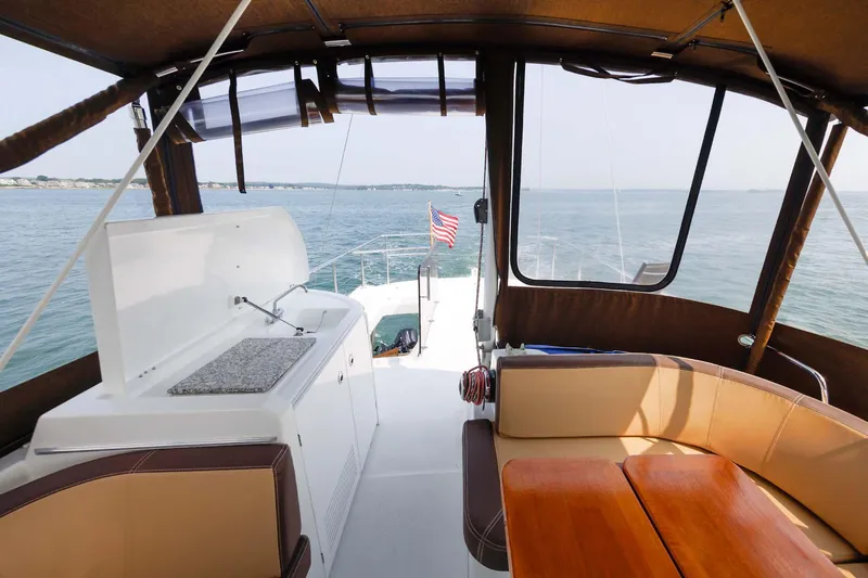Gotali Yacht Photos Pics 2016 Beneteau Swift Trawler 44 interior with seating, table, and ocean view.