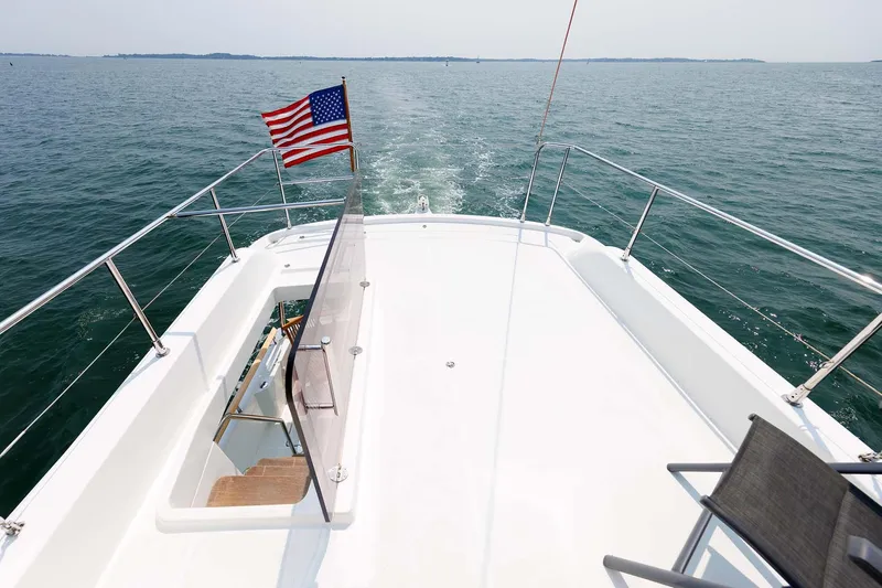 Gotali Yacht Photos Pics 2016 Beneteau Swift Trawler 44 cruising with American flag on open water.