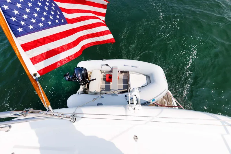 Gotali Yacht Photos Pics 2016 Beneteau Swift Trawler 44 with American flag and dinghy on water.