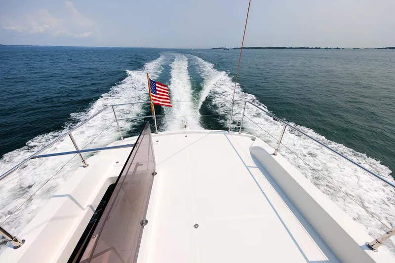 Gotali Yacht Photos Pics 2016 Beneteau Swift Trawler 44 cruising on open water, American flag waving.