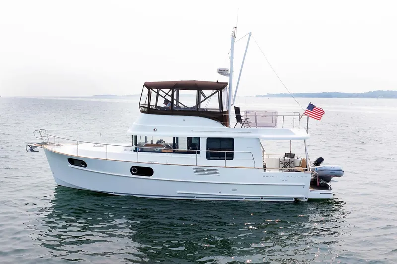 Gotali Yacht Photos Pics 2016 Beneteau Swift Trawler 44 cruising on calm waters with American flag.