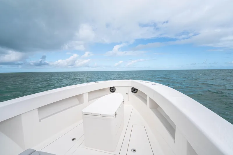  Yacht Photos Pics Bow view of SeeVee 32 boat, 2099 model, on open sea under cloudy sky.