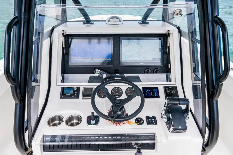  Yacht Photos Pics Futuristic SeeVee 32 boat dashboard with advanced navigation screens, steering wheel, and controls.
