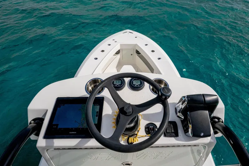  Yacht Photos Pics Steering console of a futuristic SeeVee 32 boat on clear blue water.