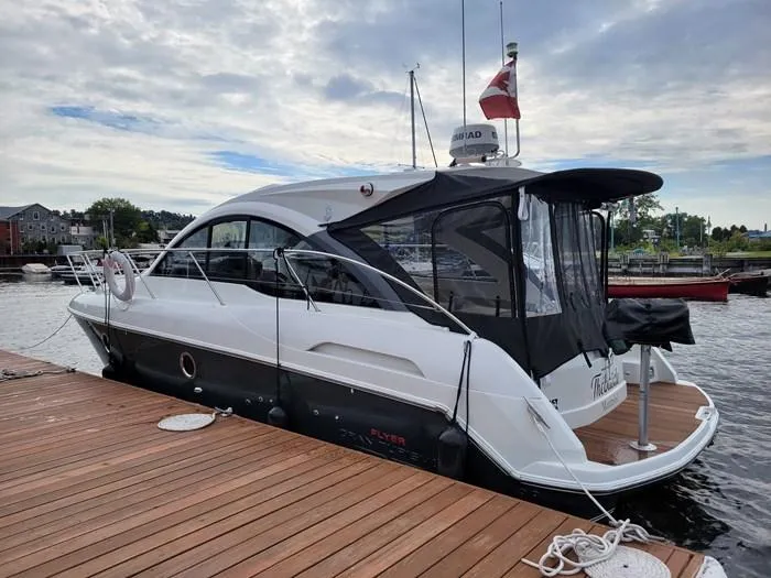  Yacht Photos Pics 2013 Beneteau Gran Turismo 34 yacht docked at marina under cloudy sky.