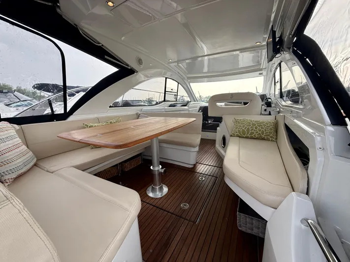  Yacht Photos Pics 2013 Beneteau Gran Turismo 34 yacht interior with elegant seating and wooden table.