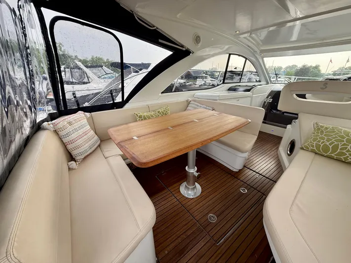  Yacht Photos Pics Interior of 2013 Beneteau Gran Turismo 34 yacht with elegant seating and wooden table.