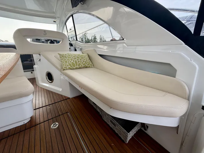  Yacht Photos Pics 2013 Beneteau Gran Turismo 34 interior with beige seating and wooden flooring.