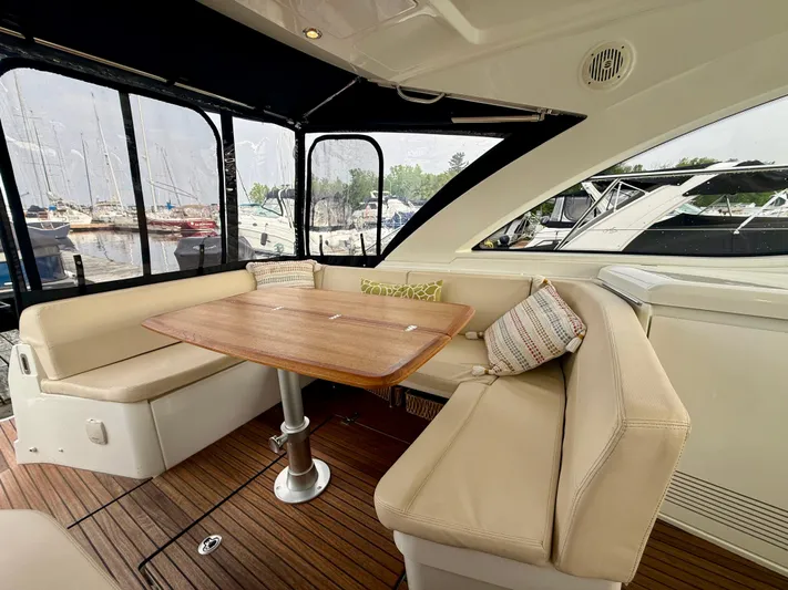  Yacht Photos Pics Luxurious interior of 2013 Beneteau Gran Turismo 34 yacht with elegant seating and wooden table.