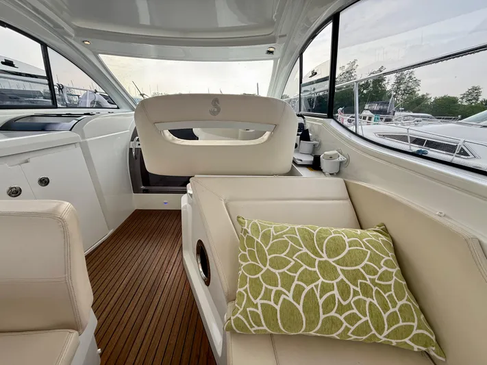 Yacht Photos Pics Interior of 2013 Beneteau Gran Turismo 34 with beige seating and green floral pillow.