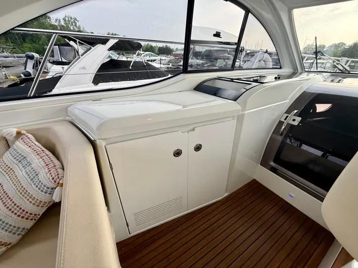  Yacht Photos Pics 2013 Beneteau Gran Turismo 34 interior with seating and cabinetry, featuring sleek design and wood flooring.