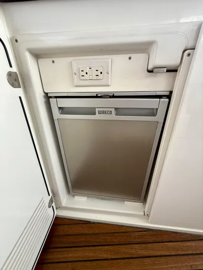  Yacht Photos Pics Built-in WAECO fridge on 2013 Beneteau Gran Turismo 34 yacht, featuring sleek design and wooden flooring.