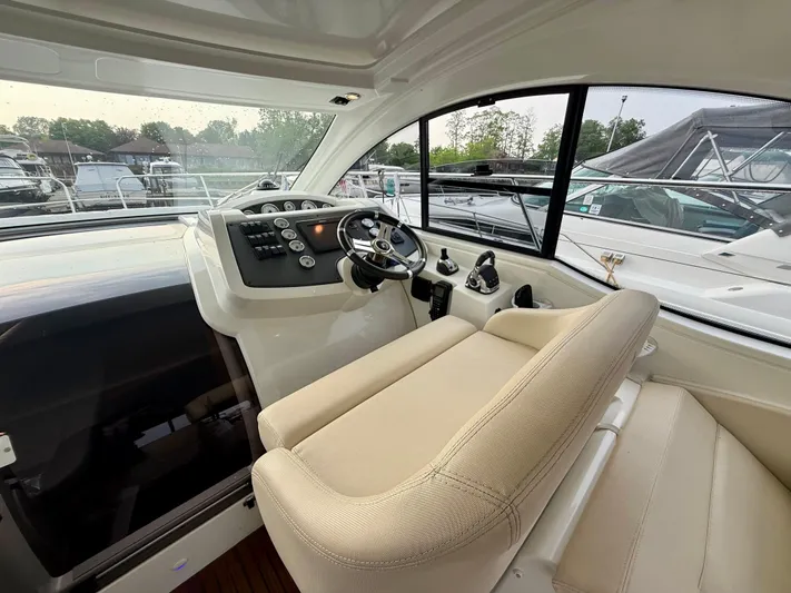  Yacht Photos Pics Interior view of 2013 Beneteau Gran Turismo 34 yacht cockpit with steering wheel and controls.