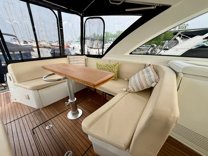  Yacht Photos Pics 2013 Beneteau Gran Turismo 34 interior with beige seating and wooden table.
