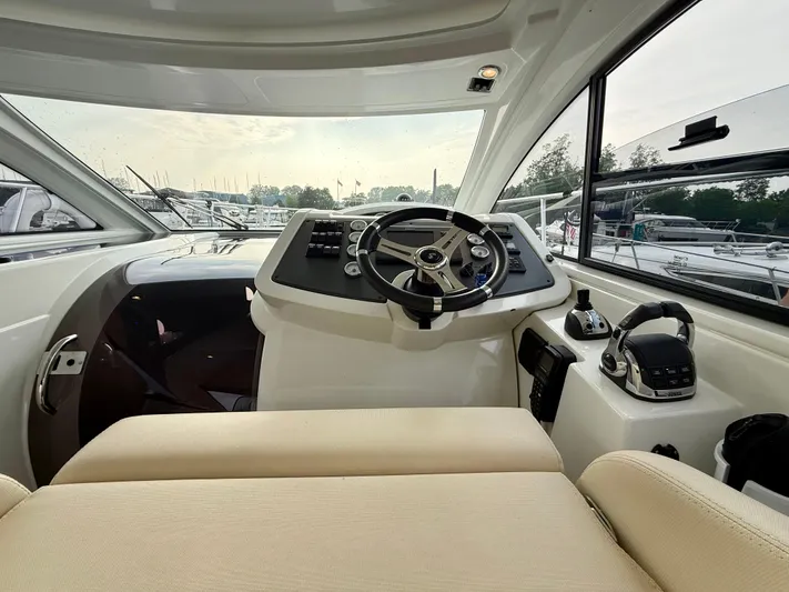  Yacht Photos Pics 2013 Beneteau Gran Turismo 34 helm with steering wheel and control panel.