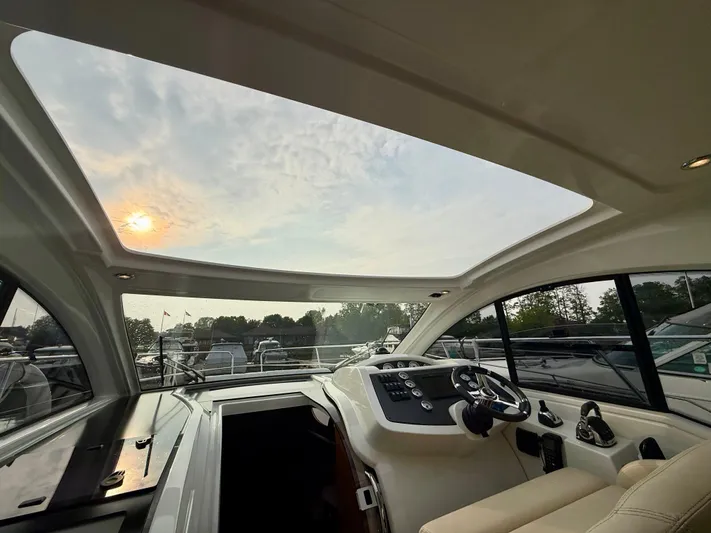  Yacht Photos Pics Interior view of 2013 Beneteau Gran Turismo 34 yacht with sunroof and steering console.