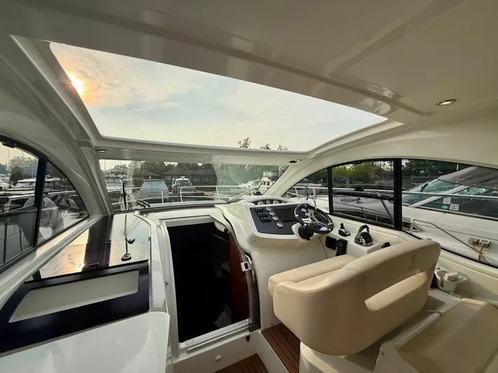  Yacht Photos Pics Interior of 2013 Beneteau Gran Turismo 34 yacht with modern helm and panoramic windows.