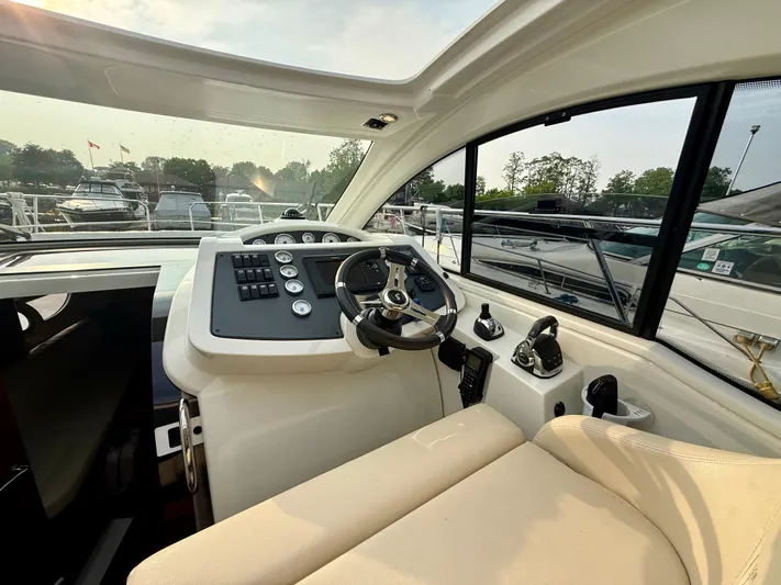  Yacht Photos Pics Helm of 2013 Beneteau Gran Turismo 34 yacht with modern controls and comfortable seating.
