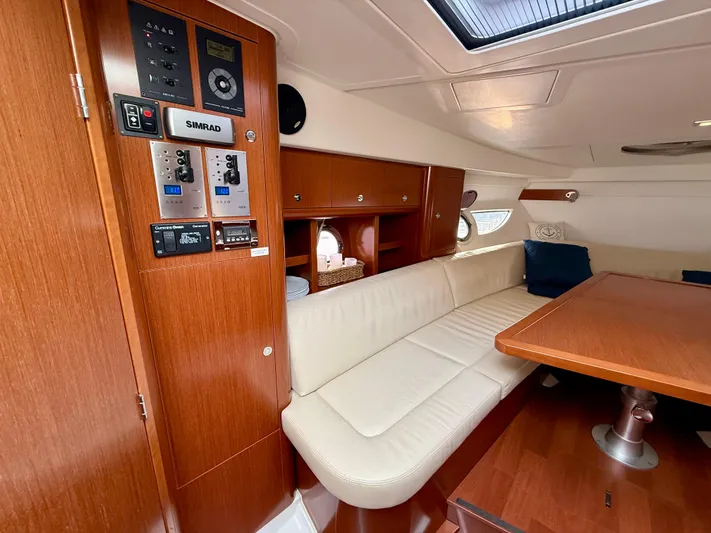  Yacht Photos Pics Interior of 2013 Beneteau Gran Turismo 34 yacht with wood paneling and cream seating.