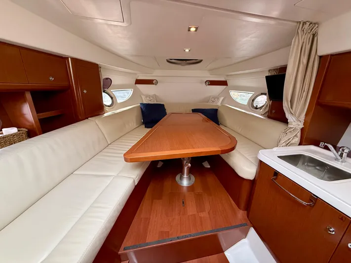  Yacht Photos Pics Interior of 2013 Beneteau Gran Turismo 34 yacht with elegant seating and wooden table.