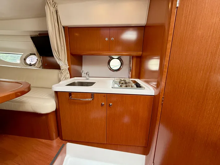  Yacht Photos Pics 2013 Beneteau Gran Turismo 34 interior with kitchenette and seating area.