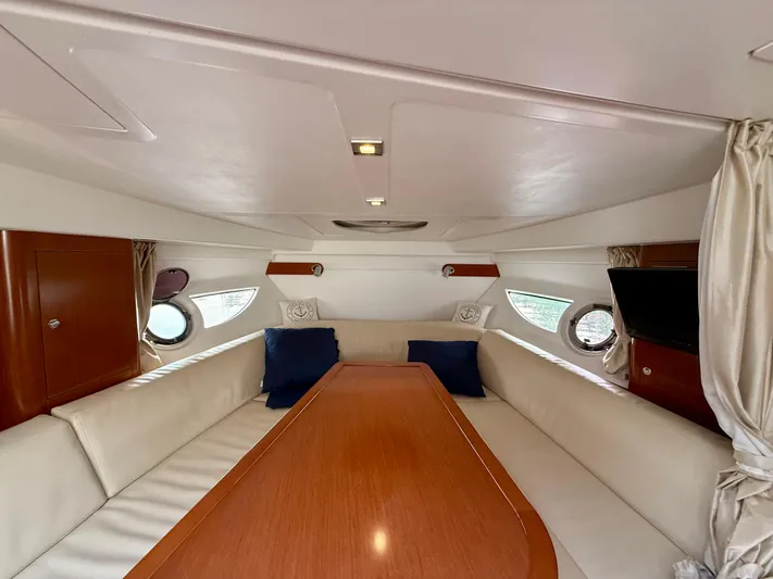 Yacht Photos Pics Interior of 2013 Beneteau Gran Turismo 34 yacht with elegant seating and wooden table.