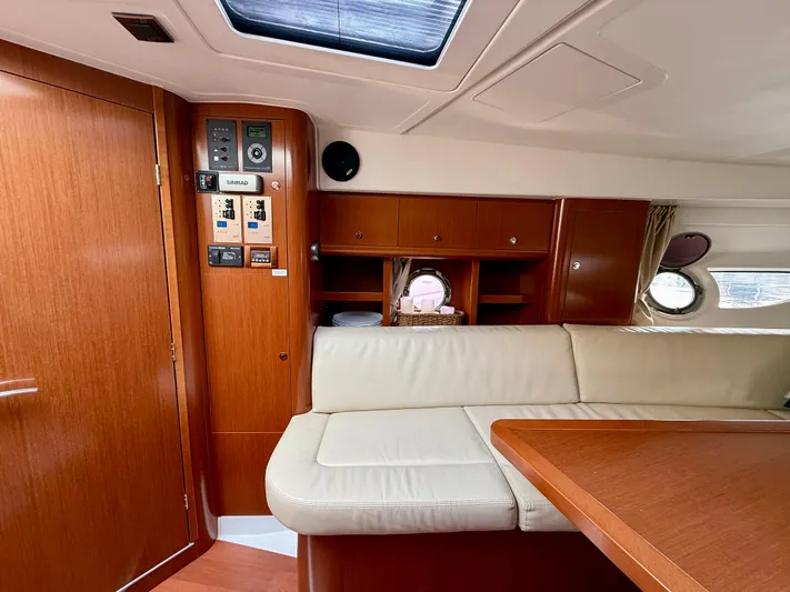  Yacht Photos Pics Interior of 2013 Beneteau Gran Turismo 34 yacht with wood paneling and beige seating.