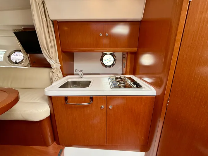  Yacht Photos Pics 2013 Beneteau Gran Turismo 34 yacht interior with kitchenette, sink, and stove.