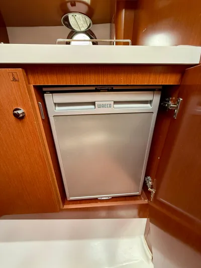  Yacht Photos Pics 2013 Beneteau Gran Turismo 34 interior with WAECO fridge in wooden cabinet.