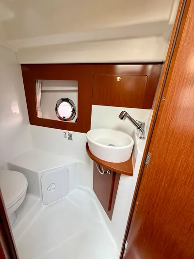  Yacht Photos Pics 2013 Beneteau Gran Turismo 34 bathroom with sink, toilet, and porthole window.