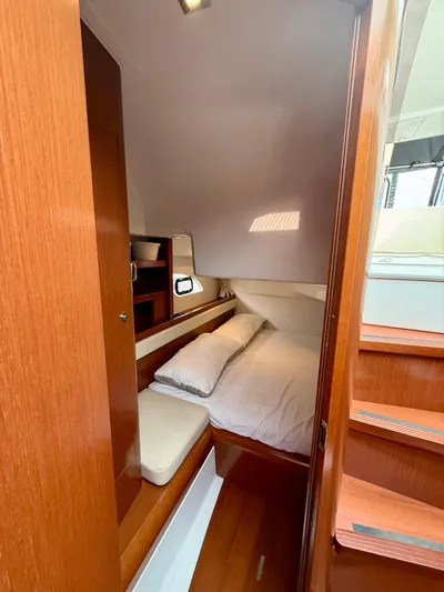  Yacht Photos Pics 2013 Beneteau Gran Turismo 34 cabin interior with cozy bed and wooden finish.