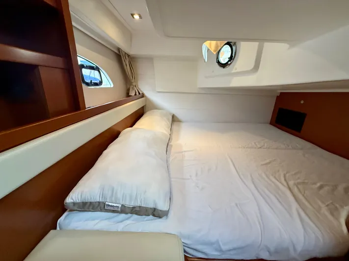  Yacht Photos Pics Cozy cabin interior of 2013 Beneteau Gran Turismo 34 yacht with bed and porthole.