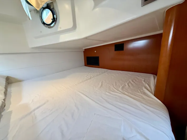  Yacht Photos Pics Cabin interior of 2013 Beneteau Gran Turismo 34 with cozy bed and porthole.