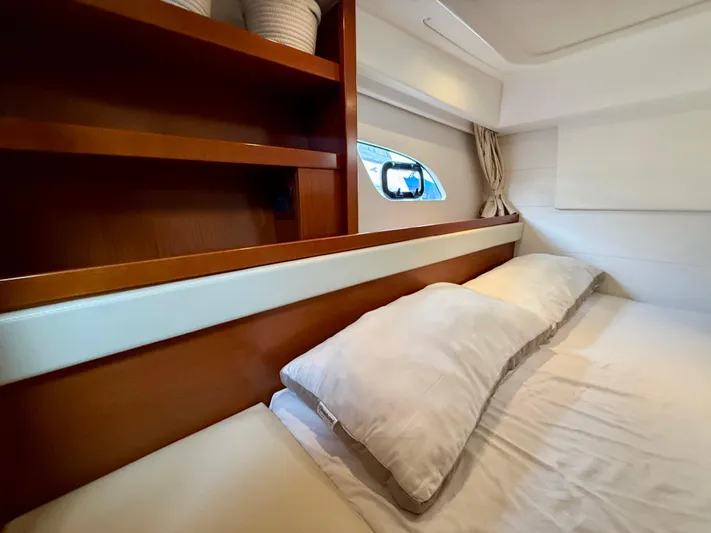  Yacht Photos Pics 2013 Beneteau Gran Turismo 34 cabin interior with bed and wooden shelving.