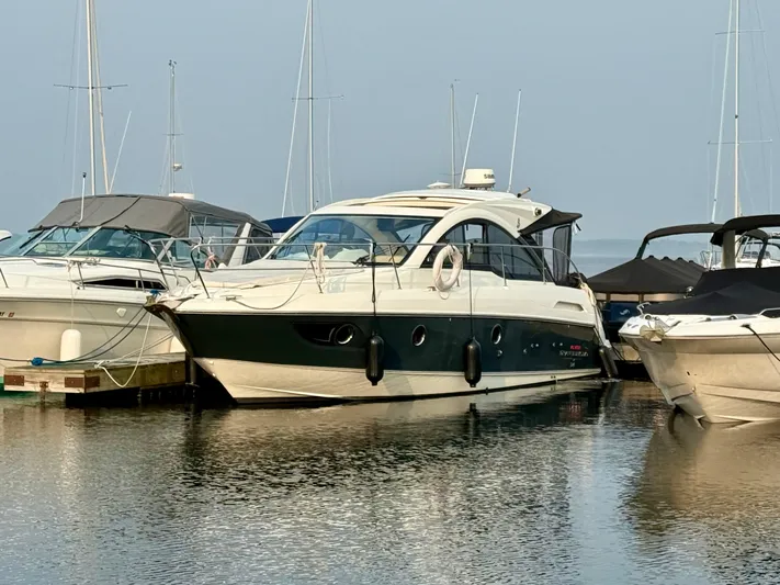  Yacht Photos Pics 2013 Beneteau Gran Turismo 34 yacht docked at marina, surrounded by other boats.