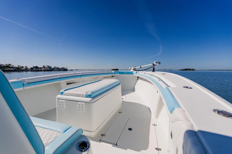  Yacht Photos Pics 2015 Yellowfin 39 Offshore boat with blue accents on calm water under clear sky.
